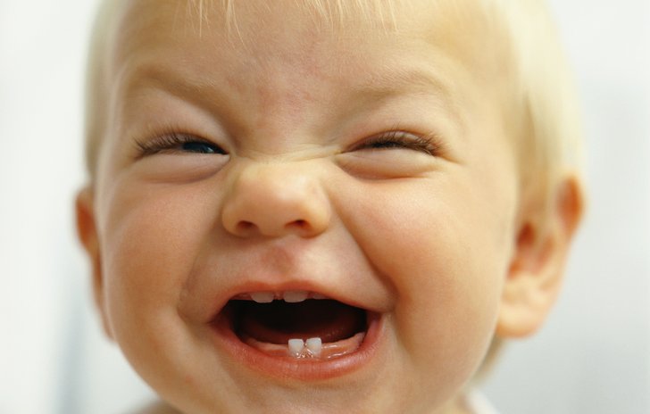 Close up of a happy baby with a big, toothy smile!