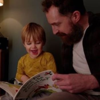 Man reading with little boy