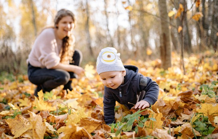 baby crawling in leaves