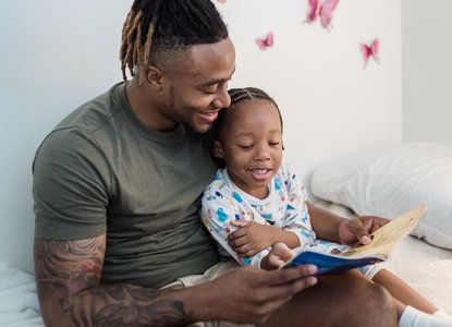 father and child reading together