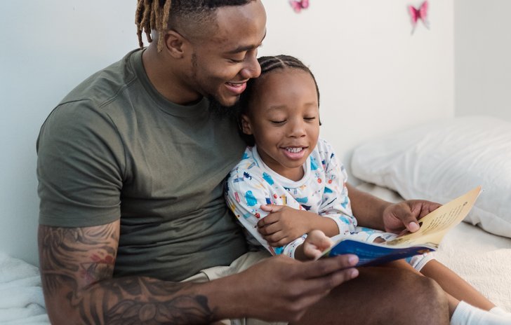 father and child reading together
