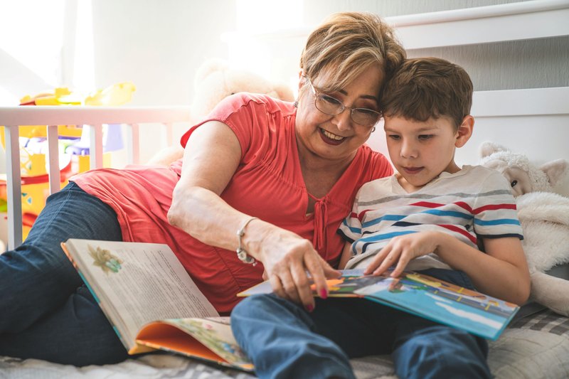 Grandmother reads with eight year old boy.