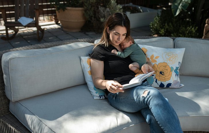 Mother reading with small baby