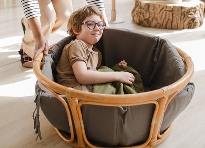child playing in basket